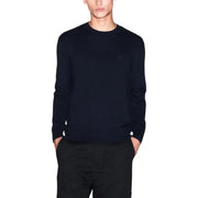 Navy blue cashmere crew neck sweater with a small embroidered logo on the left chest.
