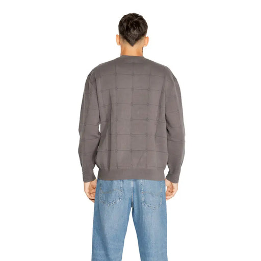 Charcoal gray quilted sweater with a checkered pattern and ribbed cuffs, collar, and hem.