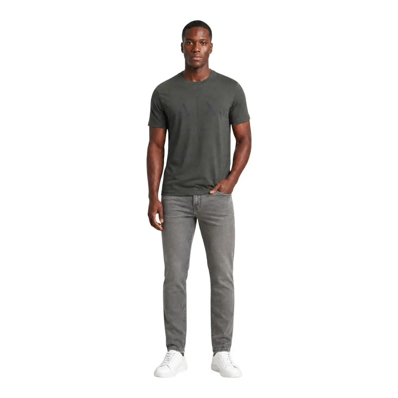 Armani exchange jeans for men in gray slim fit worn by model with dark olive green crew neck t-shirt front view
