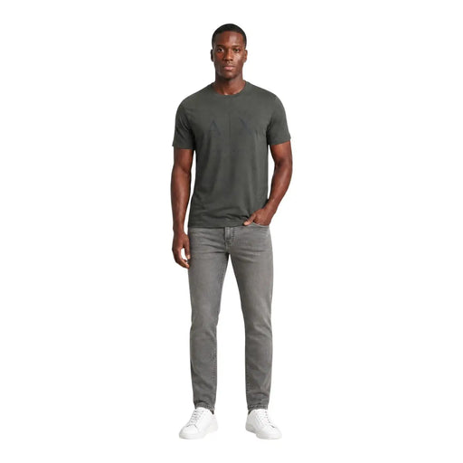 Armani exchange jeans for men in gray slim fit worn by model with dark olive green crew neck t-shirt front view