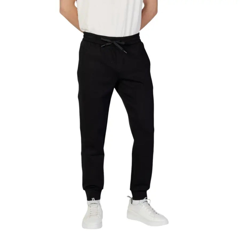 Armani Exchange men black plain laced trousers featuring a drawstring waistband and ribbed cuffs in jogger style