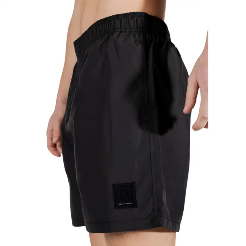 Armani exchange Short de bain noir pour homme en polyester avec taille élastique et logo discret sur le bas de la jambe