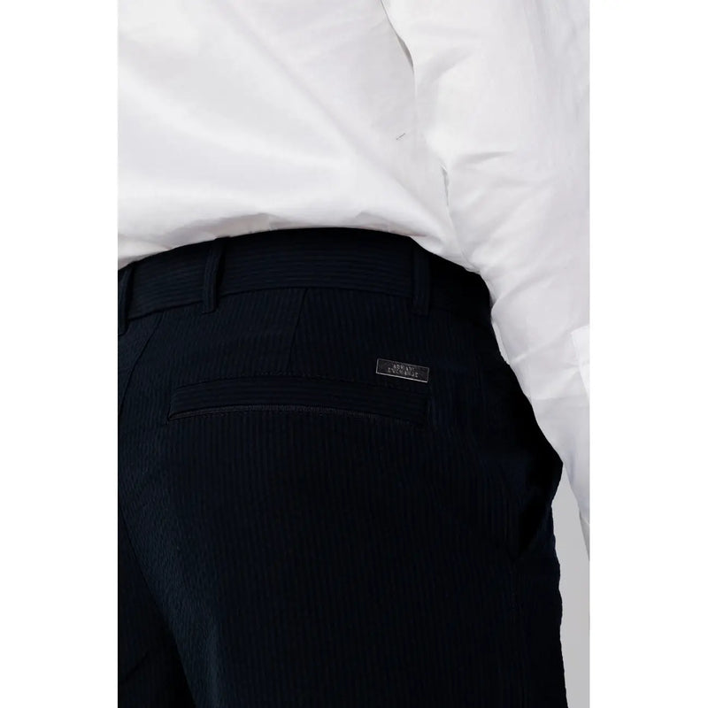 Back side of black textured Armani Exchange men cotton trousers with subtle pinstripe and brand label on pocket