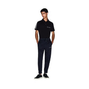 Black polo shirt with white sleeve stripes and embroidered logo paired with Armani Exchange men blue poly blend trousers