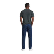 Dark blue denim jeans with five-pocket design and subtle thigh fading paired with Armani Exchange men green cotton t shirt