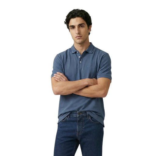 A man wearing an Armani Exchange men polo navy blue short sleeve cotton elastane shirt with embroidered logo