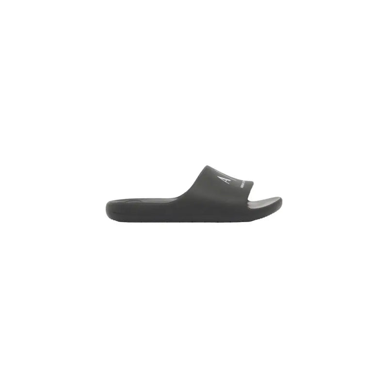 Black calvin klein slide sandal with minimalist design and subtle white logo on strap for men rubber slippers