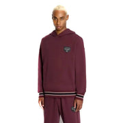 Armani Exchange Sweat-shirt homme bordeaux à capuche avec poche, logo Puma bordeaux et poignets rayés noirs et blancs.