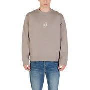 Men’s solid color long-sleeved crewneck sweatshirt with chest logo paired with blue jeans