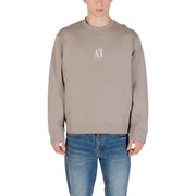 Men’s solid color long-sleeved crewneck sweatshirt with chest logo paired with blue jeans