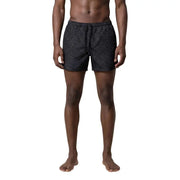 Armani Exchange men swimwear black swim trunks with a subtle repeating light gray interlocking letters pattern