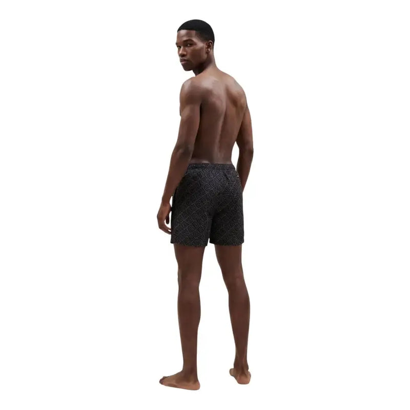 Armani Exchange men swimwear black swim trunks with a subtle geometric pattern for stylish beachwear