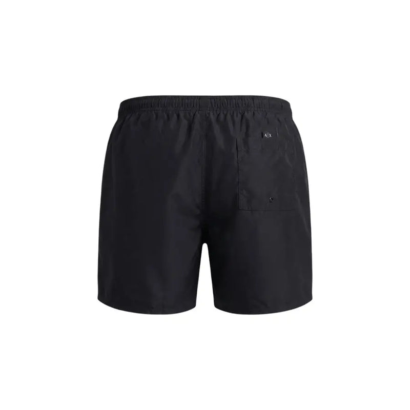 Back side of black Armani Exchange men swimwear swim trunks with subtle elastic waistband and small back pocket with logo