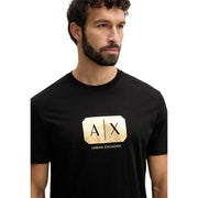 Black Armani Exchange men t-shirt featuring a prominent gold foil a|x logo and brand name on the front