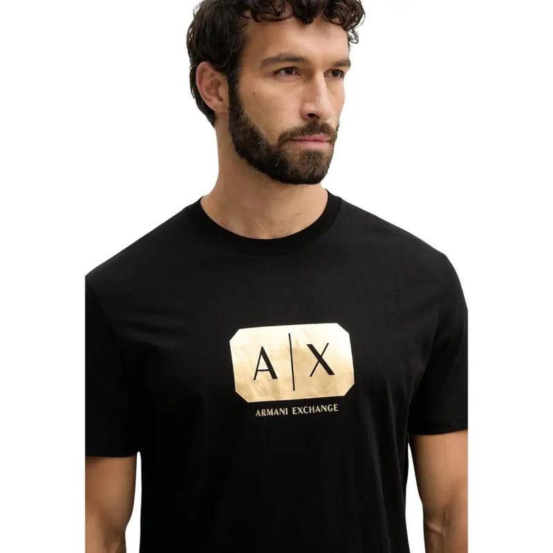 Black Armani Exchange men t-shirt featuring a prominent gold foil a|x logo and brand name on the front
