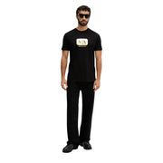 Black Armani Exchange men t-shirt featuring a gold and white logo on the chest, ideal for casual wear