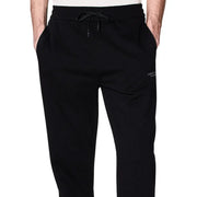 Black cotton armani exchange men trousers featuring joggers design with drawstring waistband and white branding on thigh