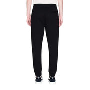 Armani Exchange men trousers black cotton joggers with tapered leg and ribbed cuffs front view