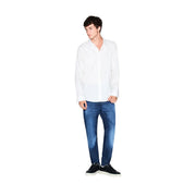 A man wearing an Armani Exchange men white cotton geometric long-sleeved button-up shirt with blue jeans