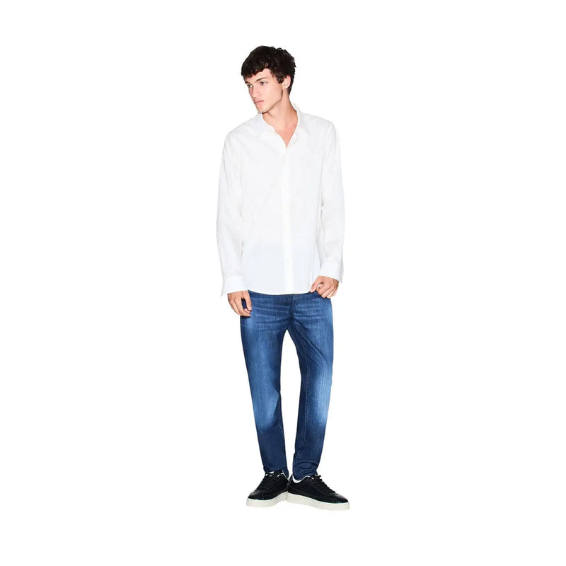 A man wearing an Armani Exchange men white cotton geometric long-sleeved button-up shirt with blue jeans