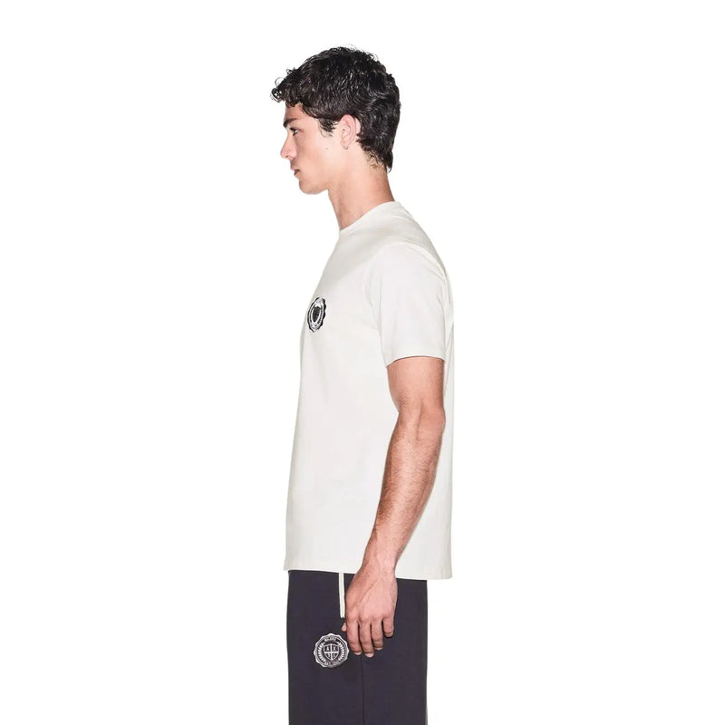 Armani Exchange men white cotton t shirt with short sleeves and black circular logo paired with navy pants embroidery