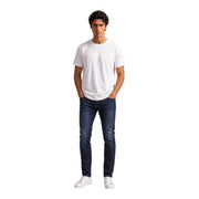 A man wearing an Armani Exchange men white cotton t shirt with a plain white crew neck and dark blue slim-fit jeans
