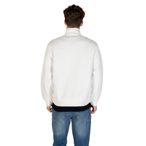 Men’s white Armani Exchange long fall winter sweatshirt with black undershirt and blue jeans