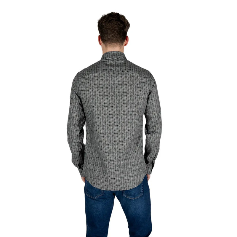 A man wearing an Armani Exchange mens black geometric long sleeve cotton shirt with a subtle patterned design