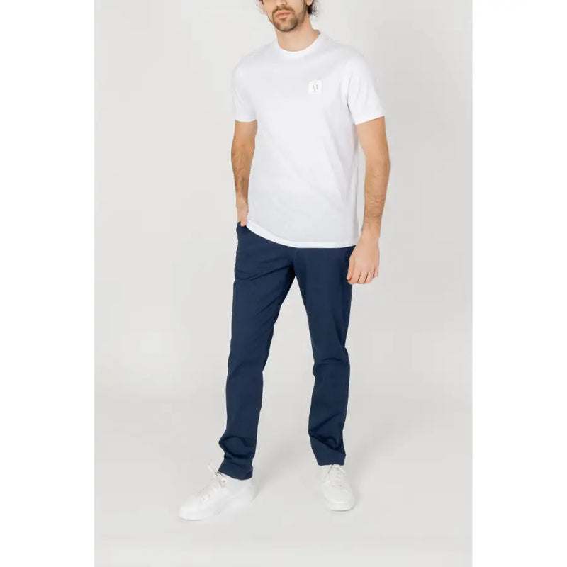 White cotton t-shirt with small logo on left chest paired with armani exchange mens blue trousers spring summer collection