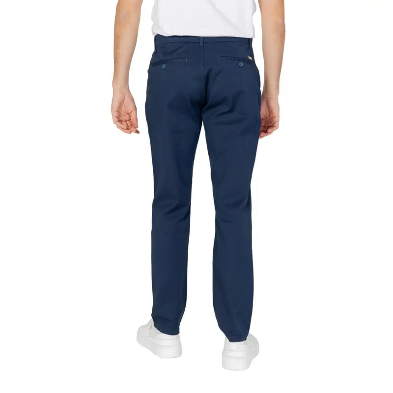 Back view of navy blue chino trousers with buttoned back pockets and subtle brand tag on right hip from Armani Exchange spring summer collection