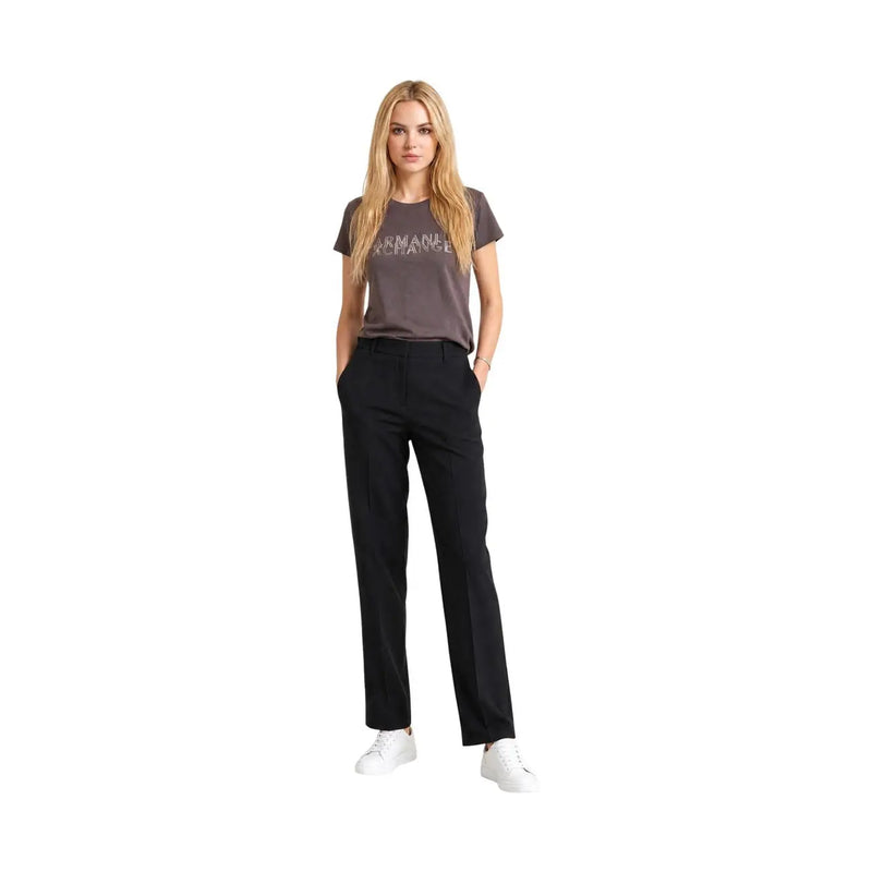 A woman wears a dark gray Armani Exchange cotton round neck t shirt with silver brand lettering across the chest