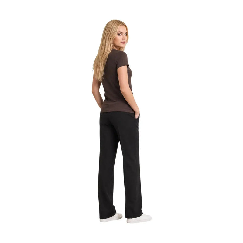 A woman wears an Armani Exchange women brown cotton v neck paillettes t shirt with black straight-leg pants
