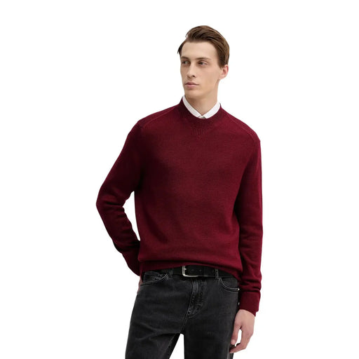 Armani Exchange wool sweater for men in burgundy with ribbed collar and cuffs worn over white collared shirt worn by model