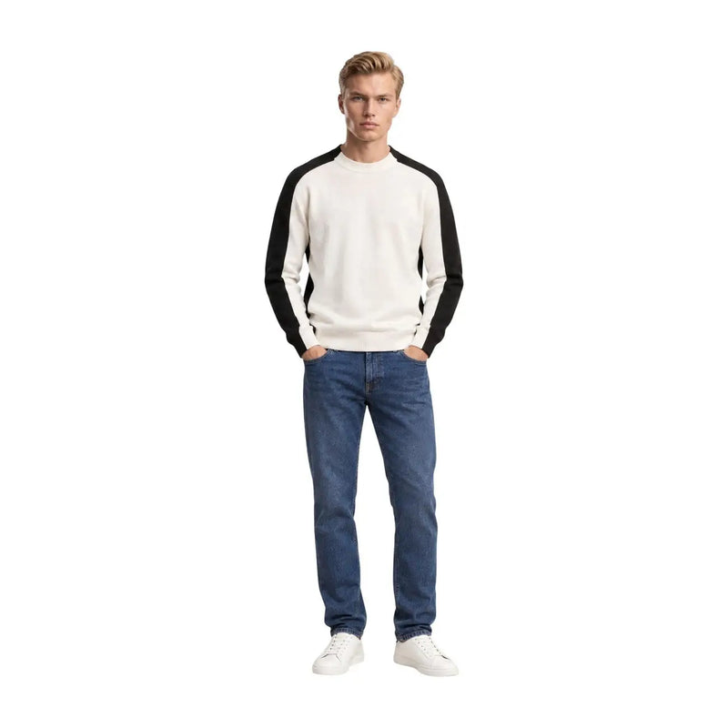 Armani Exchange wool sweater for men in cream and black with raglan sleeves and crew neck, worn by model with blue jeans