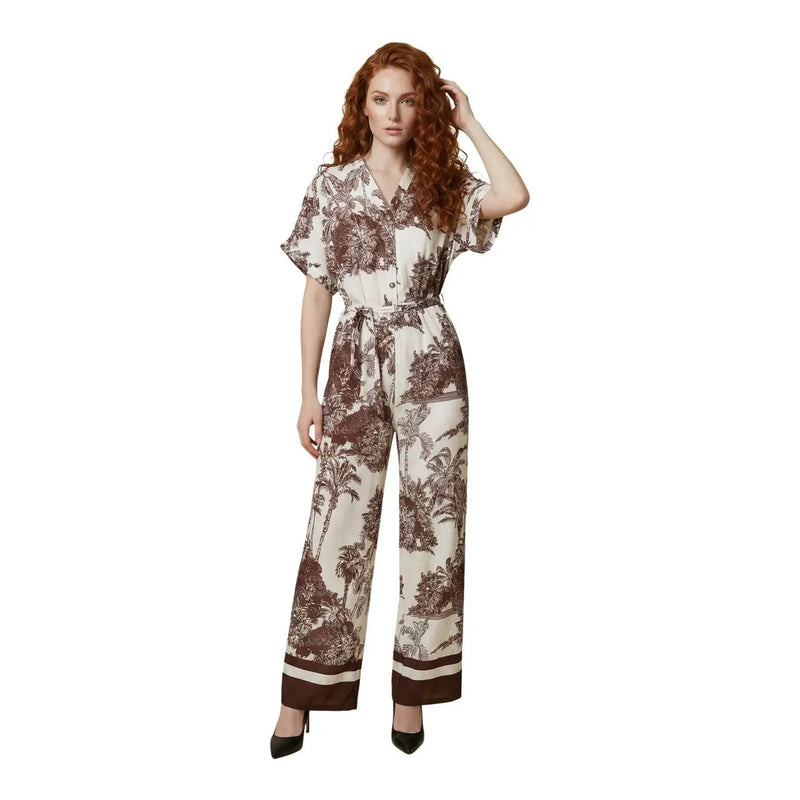 A woman wears an Artigli women floral jumpsuit beige viscose v neck with brown botanical print and matching waist belt