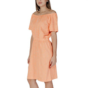 A soft peach b.young orange polka dot short off-the-shoulder dress with delicate white dot pattern and short sleeves