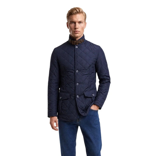 Barbour quilted jacket Lutz for men in navy blue with stand-up collar and brown leather neck trim, front view
