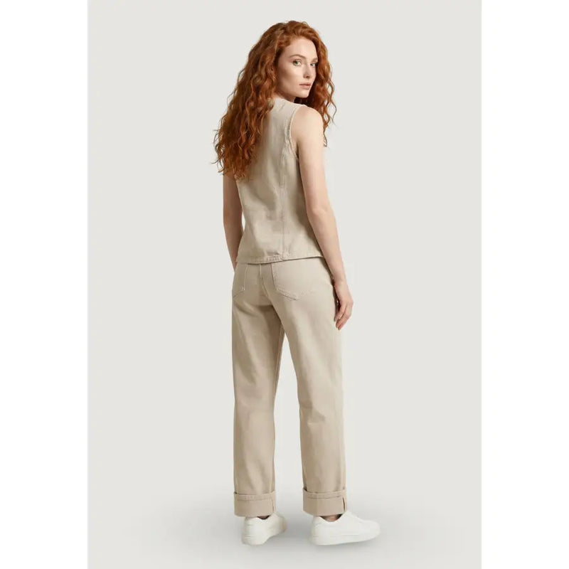Beige cotton sleeveless button front gilet for women with a relaxed fit and subtle stitching details