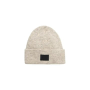 Beige knit beanie featuring a stylish black patch for contemporary accessory appeal