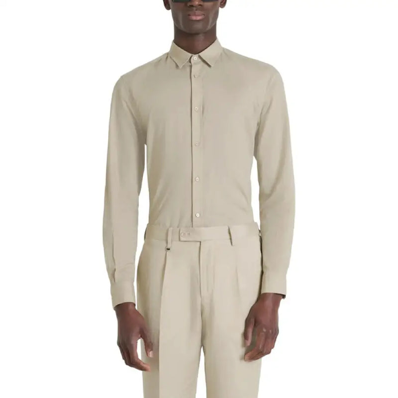 Beige long-sleeved dress shirt and trousers displayed in a product image