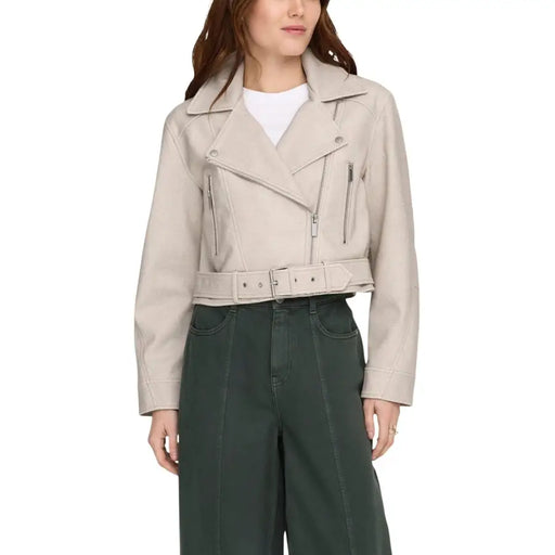 Beige polyester long blazer with v neck featuring a faux leather moto jacket style with silver zippers and matching belt