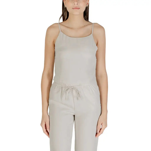 Beige sleeveless round neck polyester top for women with delicate spaghetti straps and gathered waistband in light gray