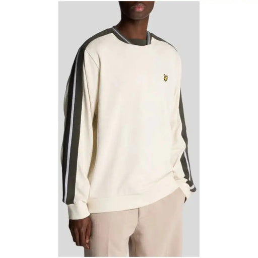 Cream and beige sweatshirt featuring a beige body with striped contrasting sleeves