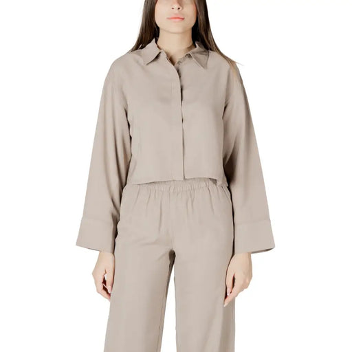 Beige viscose long sleeve round neck blouse for women with relaxed fit button-up design and pleated cuffs