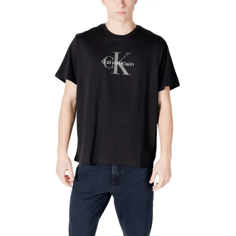 Black Calvin Klein t shirt in cotton with a silver CK logo and brand name printed across the chest