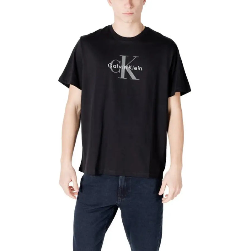 Black Calvin Klein T shirt paired with dark blue jeans in a stylish casual outfit