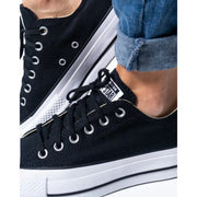 Black canvas low-top platform sneakers with white soles and laces from Converse Women