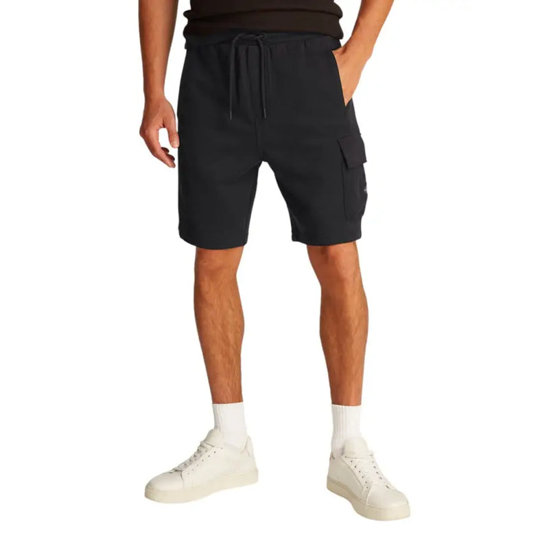 Black cargo shorts displayed with a black tank top for men’s casual wear