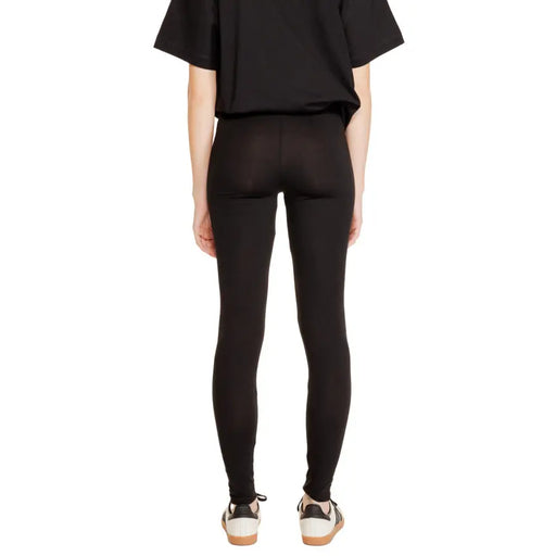 Black cotton leggings for women by Jacqueline De Yong with high waist smooth form-fitting material and subtle seam detailing