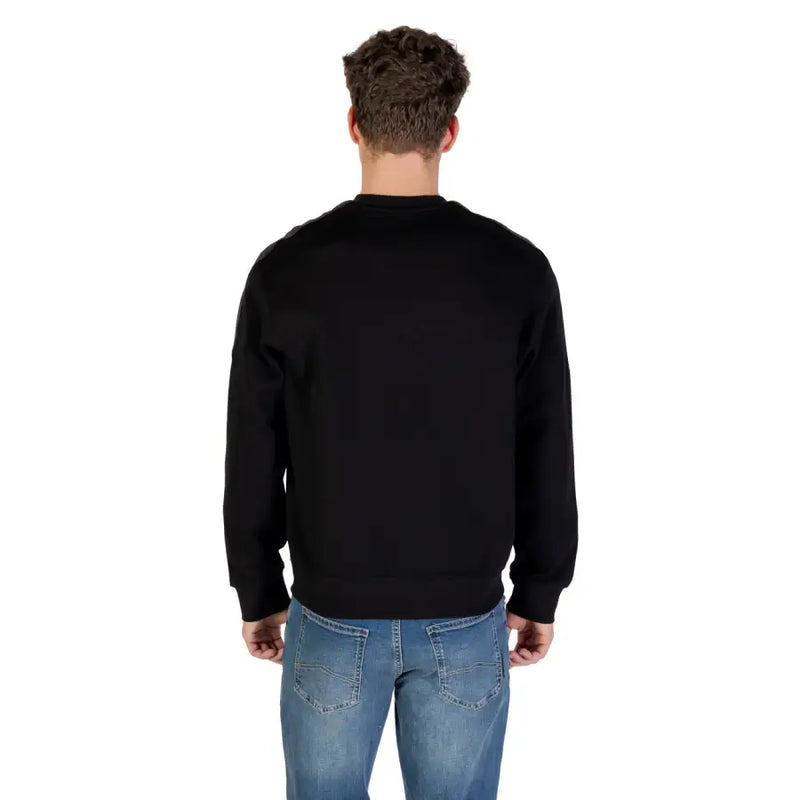 Black crewneck sweater with long sleeves ribbed cuffs and soft fabric ideal for casual wear